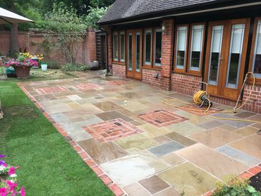 Patio paving feature paving Indian sandstone paving. Brick edging turfing landscaping esher walton