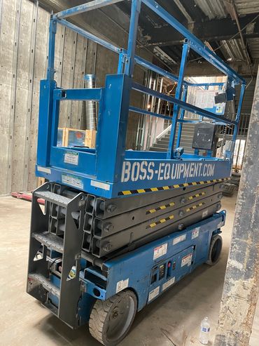 Genie 2632 Scissor lift going tough on the project making it a smooth ride.