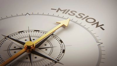 A compass pointed at the words mission.