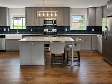 Modern kitchen with gray cabinets and island.