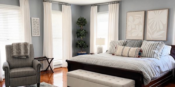 Cozy bedroom with a large bed and armchair.