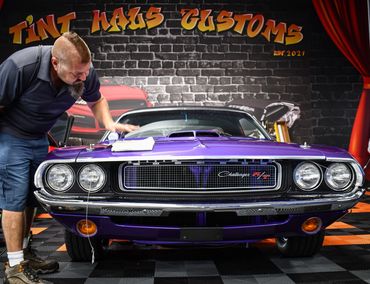 Trainer applying ceramic coating on a Dodge Challenger at Auto Film Academy