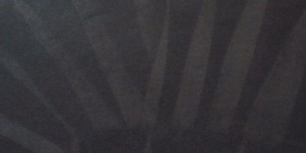 Dark image with shadowed vertical lines.