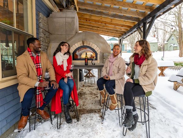People sitting outside of Betty's at the Kitch'inn in Mahone Bay, Nova Scotia in the winter