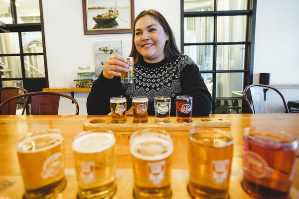 Bed and Breakfast guest enjoying a flight of craft beer at Saltbox Brewery in Mahone Bay, NS