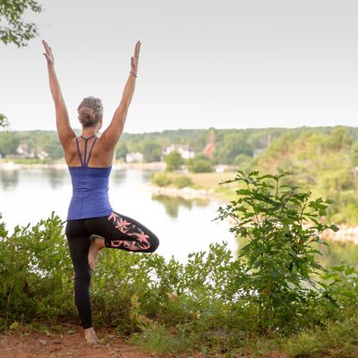 Woman in yoga pose with view of the river
