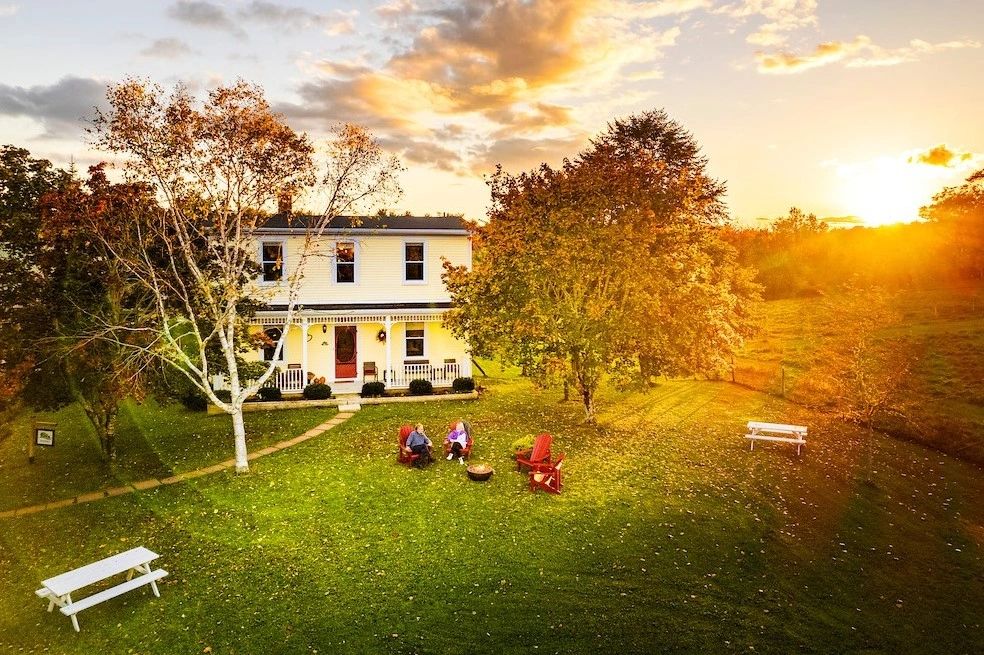 Aerial Shot of two bed & breakfast guests sitting in front of River Ridge Lodge near Mahone Bay, NS