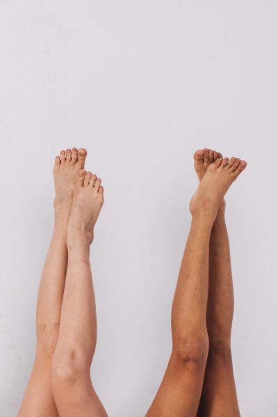 Two pairs of legs raised against a white background.