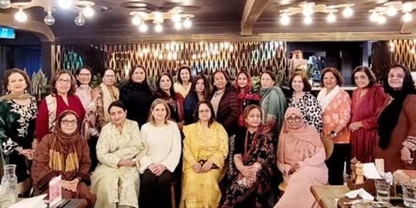 Group of women posing indoors.