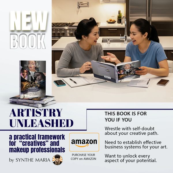 Two creative professionals discussing the book 'Artistry Unleashed' in a modern kitchen setting.