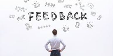 person looking at a board with feedback written on it