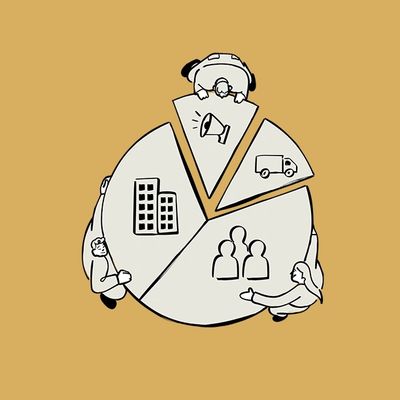 People collaborate around a pie chart divided into segments with different icons.