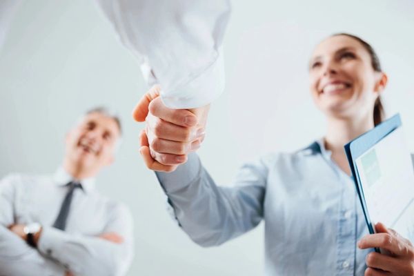 A woman giving shake hand to the other person