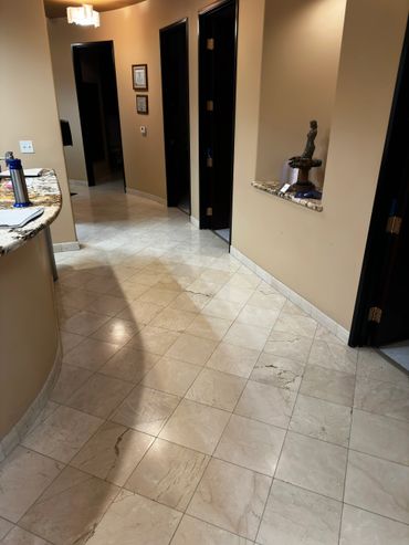 Hallway with marble tile floor and beige walls.