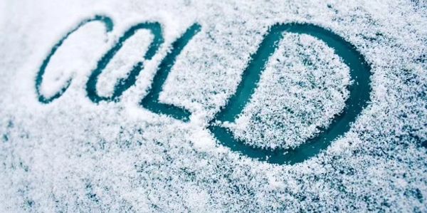 The word 'COLD' written on a snow-covered surface.