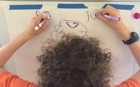 A young man does the Brain Gym® "Double Doodle" activity.