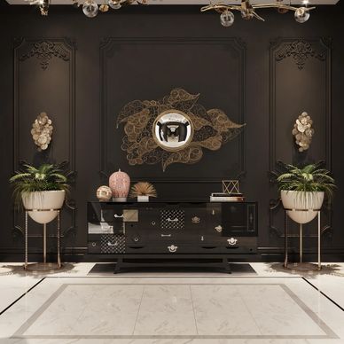 Elegant black and gold living room wall with decorative mirror and plants.