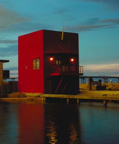 red house overlooks marina development
