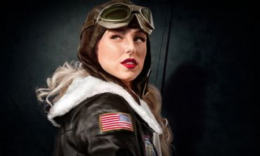 Woman pilot in vintage aviator gear with American flag patch.