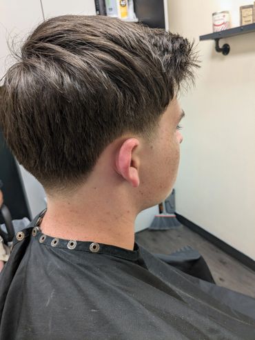 Fresh short haircut with a clean fade on the sides and back.
