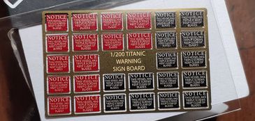 Sheet of miniature Titanic warning signs in red and black for model building.