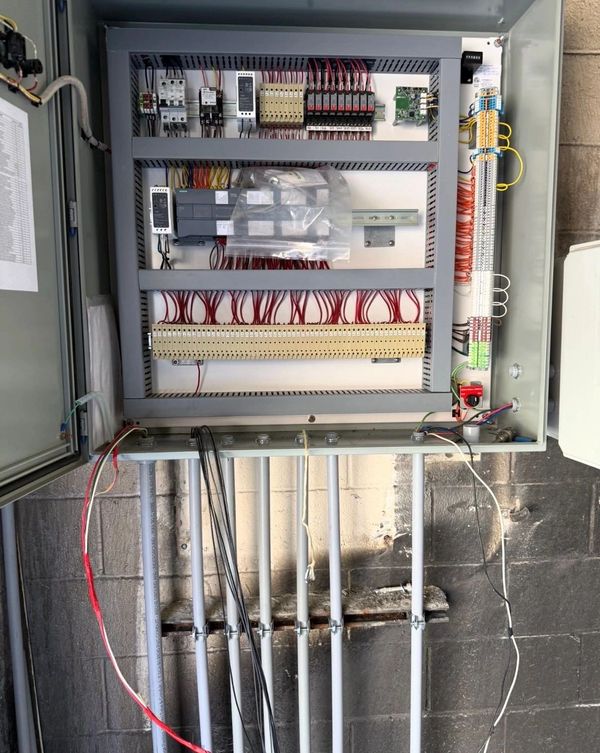 Open electrical control panel with organized wiring and circuit components.