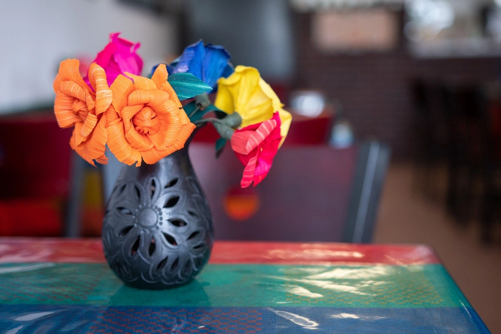 Flower pot with multicolor flowers on a table