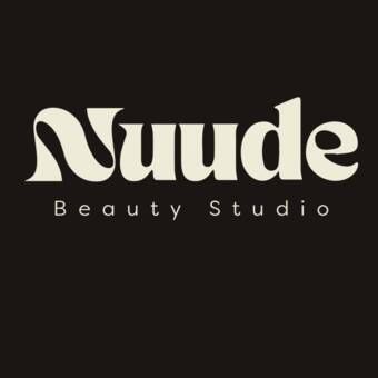 Logo of Nuude Beauty Studio with stylish font on dark background.