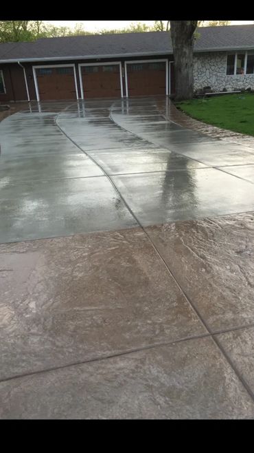 Stamped Concrete driveway along perimeter with broom  finish concrete in Center