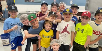 Group of young boys smiling together indoors.