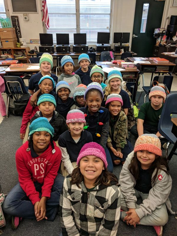 children wearing crocheted caps