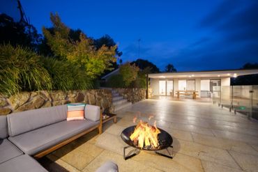 Fire pit area with natural stone retaining wall with Granite paving