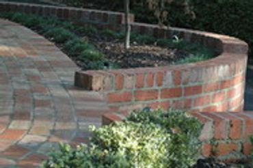 Red Brick pathway and curved garden bed area