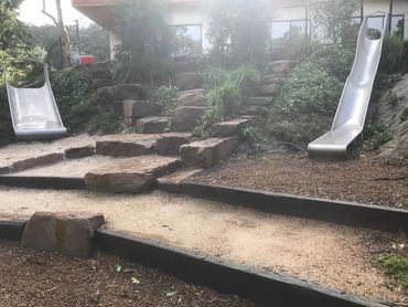 Playground Install including Mudrock steps and stainless steel slides and garden areas