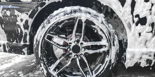 alt="soapy wheel at car wash" in touch free Olathe car wash