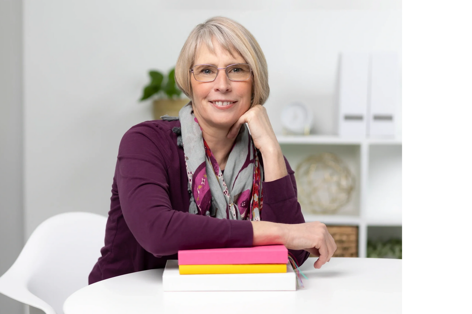 Photo of Ellen Whalen sitting at a table.