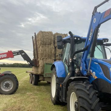 Loading square bales of hay in our tractors