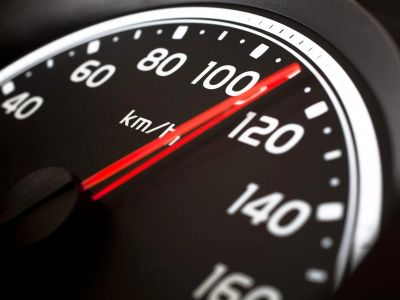 A car speedometer showing a speed of about 110 km/h.