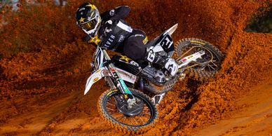 A motorcycle racing through sand