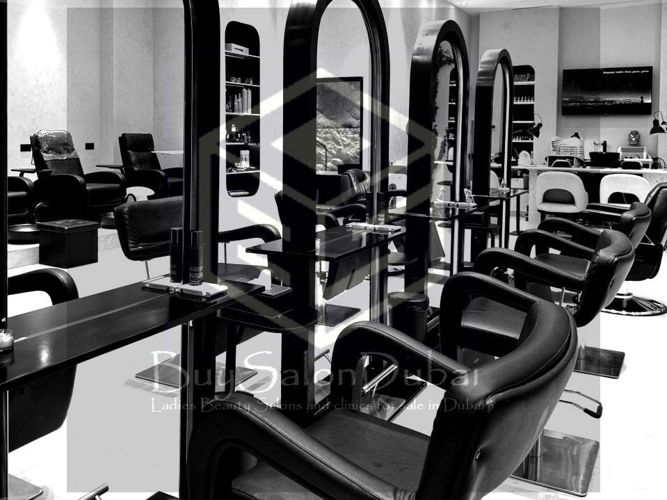 Modern black and white beauty salon with sleek chairs and mirrors.