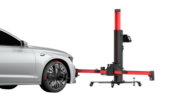 Car wheel alignment equipment attached to a silver sedan's front wheel.