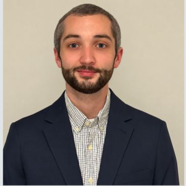 Young man in a suit and checkered shirt.