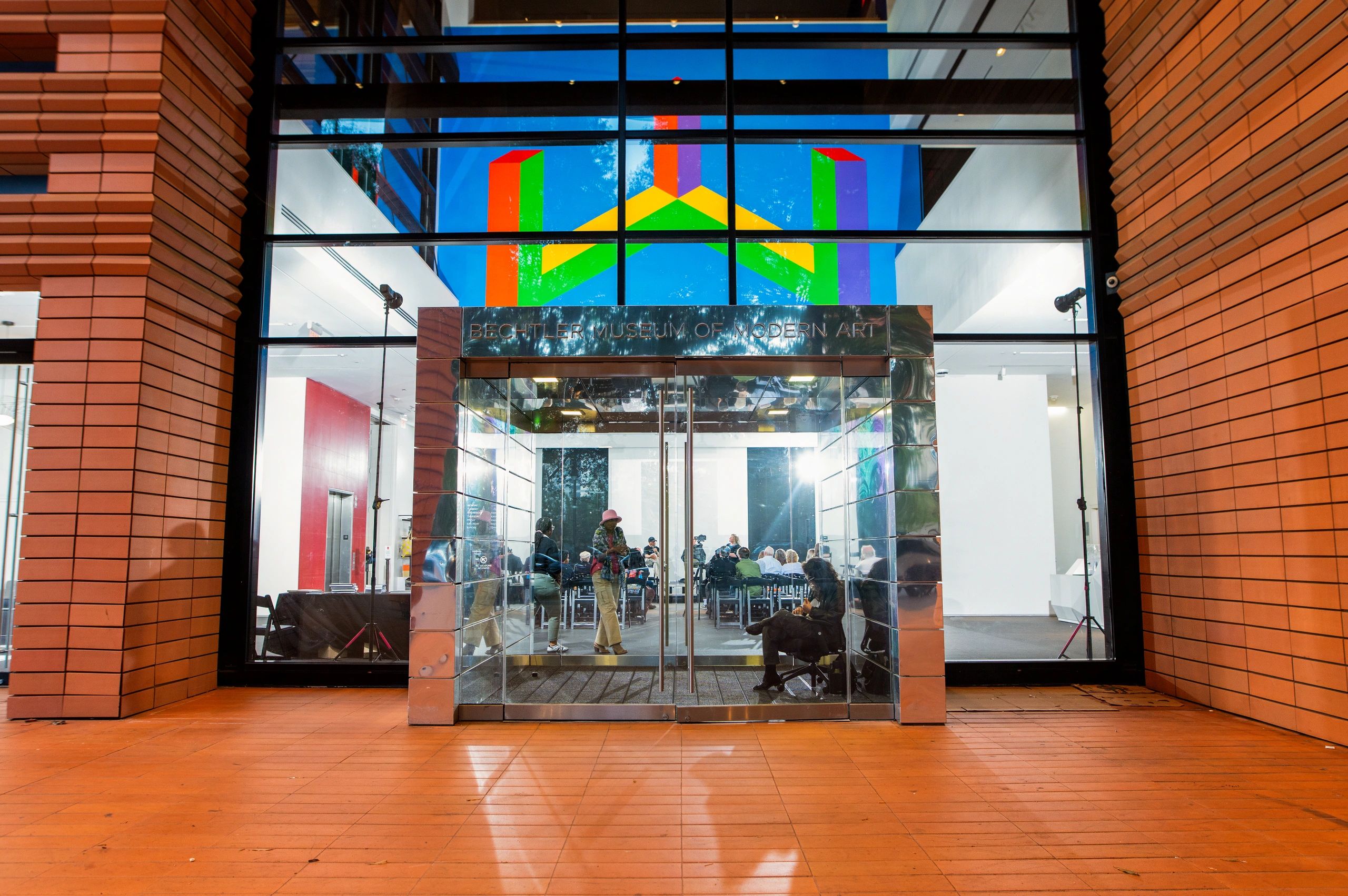 People attending an artist talk at The Betchler Museum