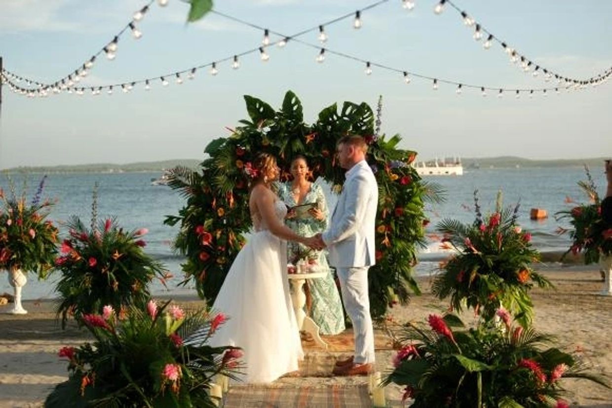 American couple celebrating a luxury destination beach wedding in Rosario Islands Cartagena by Kathy