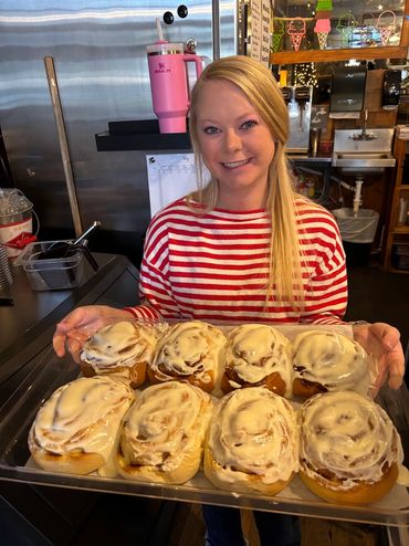 Austin holding a tray of cinnamon rolls