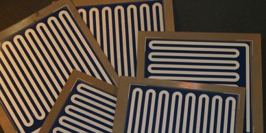 Selection of heaters on steel, screen printed circuits, high temperature cermet and polymer pastes