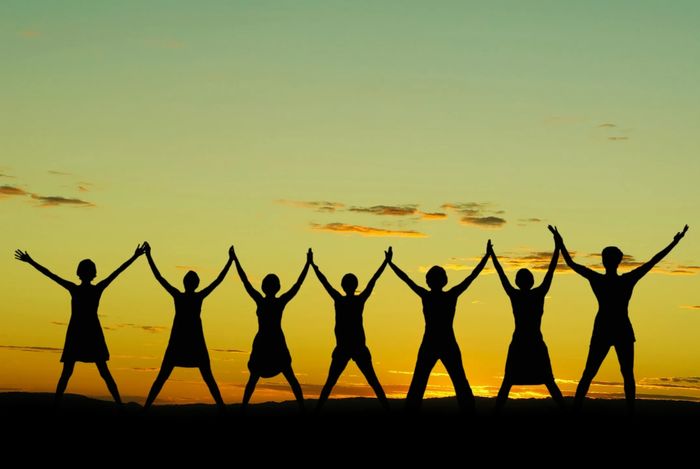 Black/Yellow photo, people,joining hands to the sky.