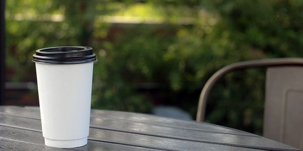 Double Wall Paper Hot Cup with black dome sip style lid. Insulated paper hot cup.