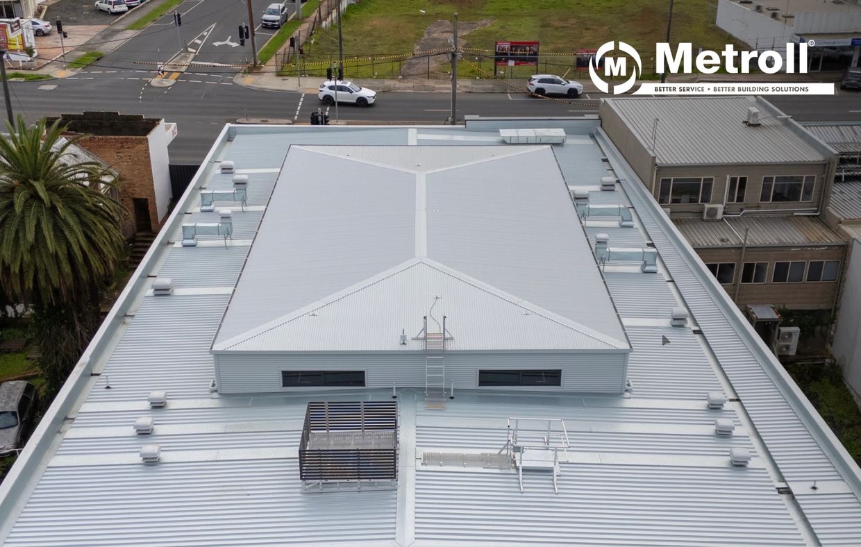 Aerial view of a modern industrial building roof with MetroII logo.
