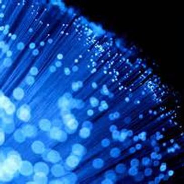 Close-up of glowing blue fiber optic cables.